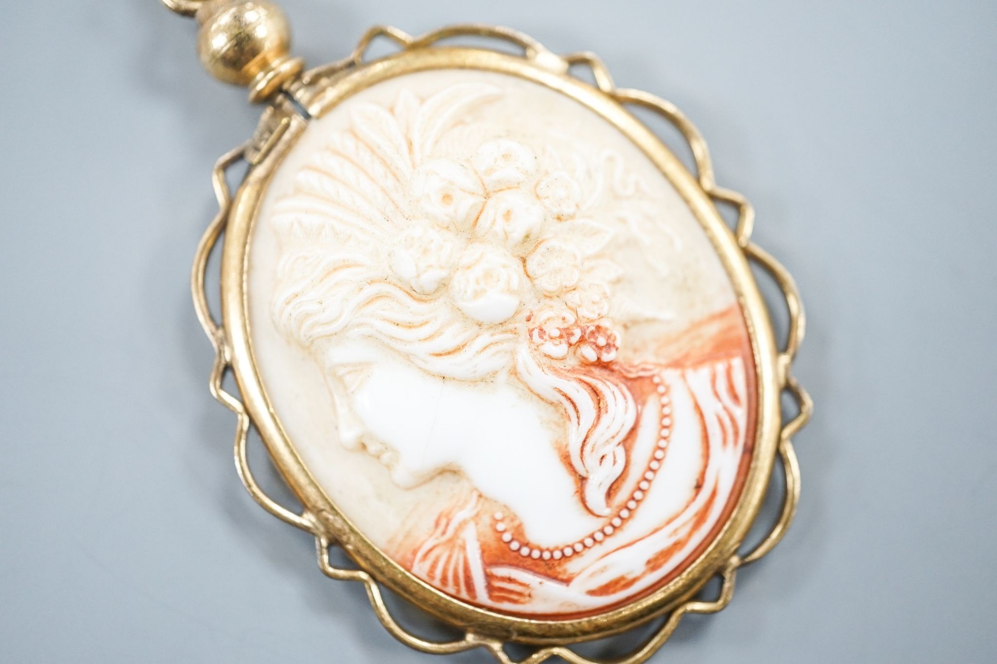 A gilt metal mounted oval ceramic? cameo pendant, 35mm.